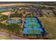 Aerial view of the community's tennis courts with trees and greenery at 7151 Sw 96Th Ct, Ocala, FL 34481