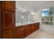 Bathroom with double sink vanity, granite countertop, and natural light at 7151 Sw 96Th Ct, Ocala, FL 34481