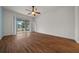 Bedroom with wood floors featuring sliding glass doors leading to a screened lanai at 7151 Sw 96Th Ct, Ocala, FL 34481