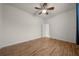 This bedroom has a ceiling fan, wood-look flooring, and white trim throughout at 7151 Sw 96Th Ct, Ocala, FL 34481