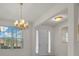 Dining Room showcasing chandelier lighting fixture and a double door entrance and window with great natural lighting at 7151 Sw 96Th Ct, Ocala, FL 34481