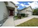 Welcoming home featuring a garden, a two-car garage, and an inviting front entrance at 7151 Sw 96Th Ct, Ocala, FL 34481