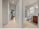 Hallway view of the bathroom which features tile flooring, a shower and a vanity at 7151 Sw 96Th Ct, Ocala, FL 34481