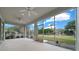 Screened lanai with ceiling fans and serene views of the fenced backyard at 7151 Sw 96Th Ct, Ocala, FL 34481