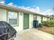 Patio area featuring a grill, seating, and well-manicured lawn with lush landscaping at 7340 Sw 111Th Ln, Ocala, FL 34476