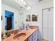 Bathroom featuring a large mirror above a double sink vanity with salmon colored countertop at 7340 Sw 111Th Ln, Ocala, FL 34476