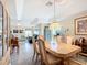 Dining area with tray ceilings, adjacent to the living room, featuring a dining table and views of the interior at 7340 Sw 111Th Ln, Ocala, FL 34476