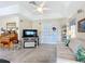 Living room with trey ceilings, fan, entertainment center, and sliding doors to the exterior at 7340 Sw 111Th Ln, Ocala, FL 34476