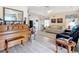 Cozy living room with wood look flooring, piano, sofa, and french doors at 7340 Sw 111Th Ln, Ocala, FL 34476