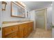 Bathroom features a wooden vanity with marble countertop and a walk-in shower at 7810 Sw 186Th Cir, Dunnellon, FL 34432