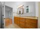 Bathroom featuring a wooden vanity with marble countertop and a window with natural light at 7810 Sw 186Th Cir, Dunnellon, FL 34432