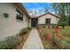 Welcoming front walkway lined with blossoming flower bushes, leading to the home's inviting entrance at 7810 Sw 186Th Cir, Dunnellon, FL 34432