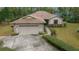 Inviting single-story home with a two-car garage, neutral exterior paint, and a well-maintained concrete driveway at 7810 Sw 186Th Cir, Dunnellon, FL 34432