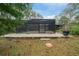 Screened-in pool area with brick flooring surrounded by mature landscaping and a lawn at 7810 Sw 186Th Cir, Dunnellon, FL 34432