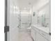 Bathroom featuring a combined shower and tub with glass doors, white vanity, and a tiled floor at 8719 Sw 76Th Street Rd, Ocala, FL 34481