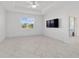 Bright bedroom featuring tile floors, a modern ceiling fan, and a window with a view of the surrounding landscape at 8719 Sw 76Th Street Rd, Ocala, FL 34481