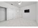 Light-filled bedroom with white tile flooring, a ceiling fan, and a wall-mounted television at 8719 Sw 76Th Street Rd, Ocala, FL 34481