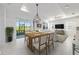 Bright dining area with backyard views, modern pendant lighting, and seamless access to the screened lanai at 8719 Sw 76Th Street Rd, Ocala, FL 34481