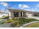 Single-story home featuring a well-manicured lawn, a large driveway, and a two-car garage at 8719 Sw 76Th Street Rd, Ocala, FL 34481