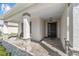 Inviting front porch with stone columns, cozy seating, and a stylish front door at 8719 Sw 76Th Street Rd, Ocala, FL 34481