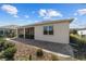 Charming rear exterior featuring a screened-in patio, manicured landscaping, and a well-maintained lawn at 8719 Sw 76Th Street Rd, Ocala, FL 34481