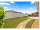 Fenced backyard with a winding stone pathway through the well-maintained lawn at 8861 Sw 63Rd Ct, Ocala, FL 34476