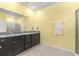 Bathroom with a double sink vanity with black cabinets and granite countertops and glass enclosed shower at 8861 Sw 63Rd Ct, Ocala, FL 34476