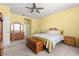 Bright bedroom with natural light, a ceiling fan, and traditional-style furnishings and decor at 8861 Sw 63Rd Ct, Ocala, FL 34476