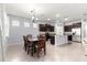 This dining room shows the table and chairs and the kitchen island with stainless appliances at 8861 Sw 63Rd Ct, Ocala, FL 34476