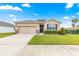 Charming single Gathering home features a two car garage, stone accents and well manicured lawn at 8861 Sw 63Rd Ct, Ocala, FL 34476