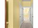 Hallway view of doors, with a bathroom featuring double sinks and a glass-enclosed shower at 8861 Sw 63Rd Ct, Ocala, FL 34476