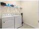 Functional laundry room with a front loading washer and dryer, plus shelving for organized storage at 8861 Sw 63Rd Ct, Ocala, FL 34476