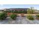 Screened-in pool area in the backyard complemented by colorful landscaping and decorative rock at 8864 Sw 85Th Loop, Ocala, FL 34481