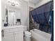 Bathroom featuring a white vanity, modern fixtures, and a bathtub with decorative tile surround at 8864 Sw 85Th Loop, Ocala, FL 34481