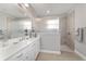 Bathroom with double vanity, glass-enclosed shower and neutral color palette at 8864 Sw 85Th Loop, Ocala, FL 34481