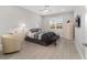 Bright bedroom featuring neutral walls, a ceiling fan, and large window at 8864 Sw 85Th Loop, Ocala, FL 34481