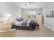 Comfortable bedroom featuring neutral walls, a ceiling fan, and a window for natural light at 8864 Sw 85Th Loop, Ocala, FL 34481