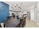 Bright dining room with modern light fixture offers an open concept view into kitchen and living spaces at 8864 Sw 85Th Loop, Ocala, FL 34481