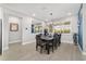 Elegant dining room features a modern chandelier, large mirror, and stylish decor at 8864 Sw 85Th Loop, Ocala, FL 34481