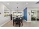 Bright dining room boasts modern light fixture, accent wall, and access to outdoor living area at 8864 Sw 85Th Loop, Ocala, FL 34481