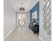 Bright entryway featuring wood floors, pendant lighting, console table, and stylish wall decor at 8864 Sw 85Th Loop, Ocala, FL 34481