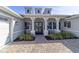 Elegant home entrance with blue accents and decorative columns on the front porch at 8864 Sw 85Th Loop, Ocala, FL 34481