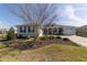 Beautifully landscaped front yard with a charming home featuring blue shutters at 8864 Sw 85Th Loop, Ocala, FL 34481