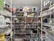 Walk-in pantry features wire shelving with storage bins and household items neatly arranged at 8864 Sw 85Th Loop, Ocala, FL 34481