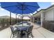 The screened-in pool area is perfect for relaxing and entertaining with seating and an umbrella-covered table at 8864 Sw 85Th Loop, Ocala, FL 34481