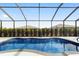 Beautiful screened-in pool with clear blue water and privacy landscaping at 8864 Sw 85Th Loop, Ocala, FL 34481