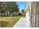 View of a well-maintained backyard with mature trees and lush green grass at 9064 Sw 91St Cir, Ocala, FL 34481