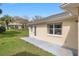 Home's backyard features a concrete patio, lawn and natural light from the clear blue sky at 9064 Sw 91St Cir, Ocala, FL 34481