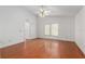 Bright main bedroom with hardwood floors, ceiling fan, and a large window at 9064 Sw 91St Cir, Ocala, FL 34481