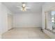 Bright and airy bedroom with neutral tile flooring, a ceiling fan, and a closet at 9064 Sw 91St Cir, Ocala, FL 34481